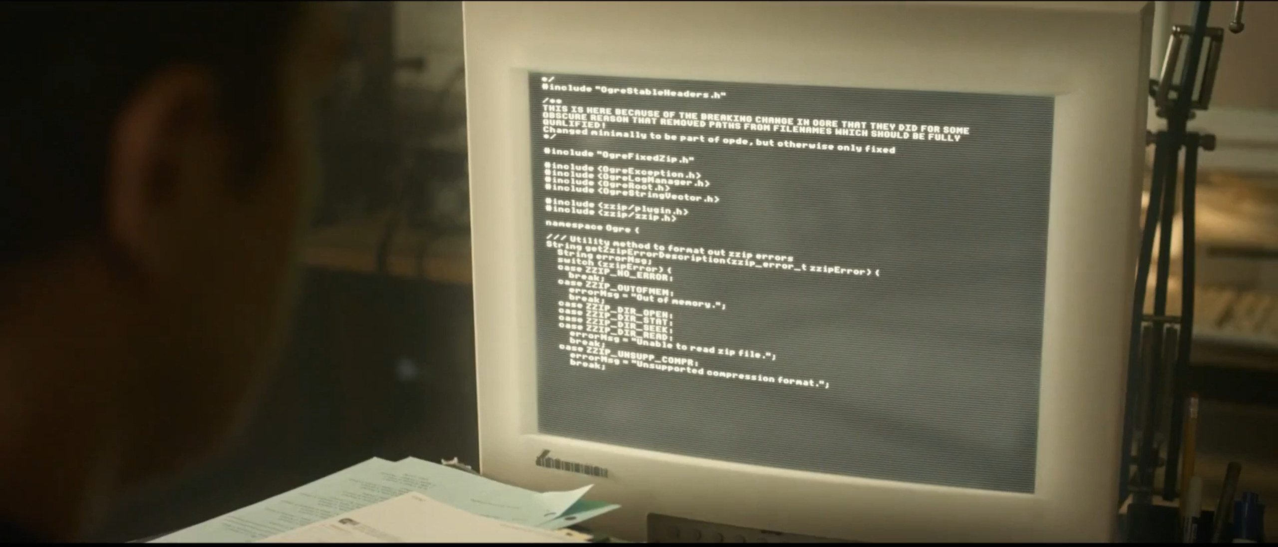 In a scene not intended to be paused on, the Amazon team watches in suspense as their lead dev pushes the beta site to prod by typing out <a href="https://github.com/volca02/openDarkEngine/blob/7a2d7baaf0fc5194a9066a635c6f44b0f7b26c56/src/main/OgreFixedZip.cpp#L29">code from a random Github repo</a>.